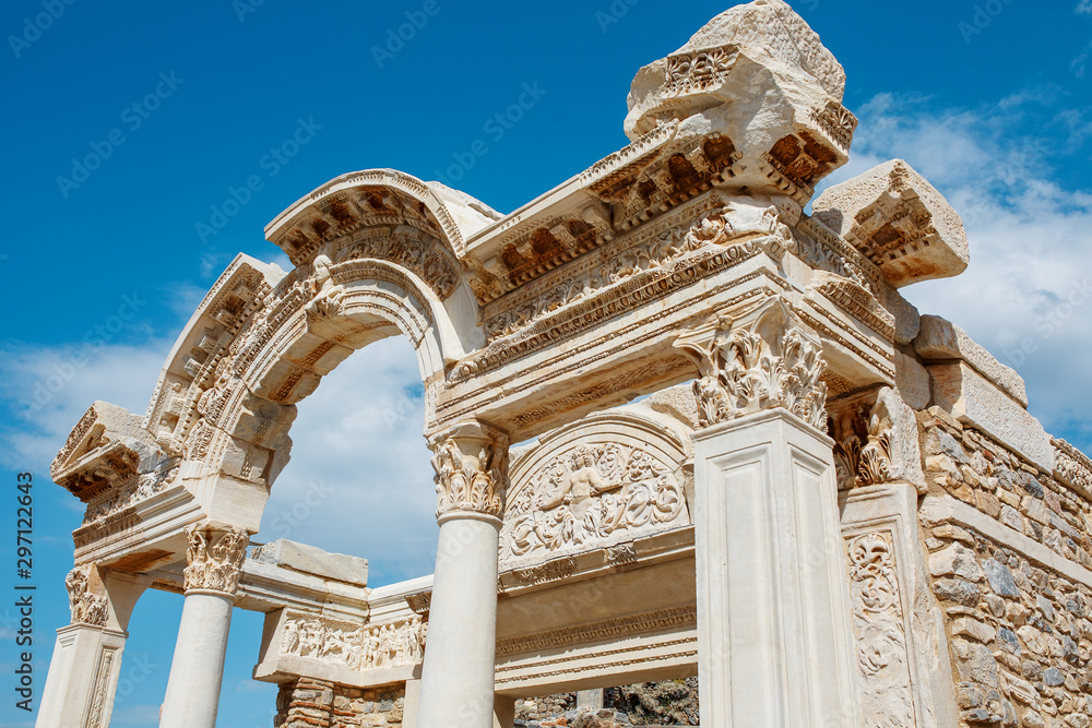 Ruins of the ancient urban architecture of the city of Ephesus, against the blue sky Temple of Hadrian.