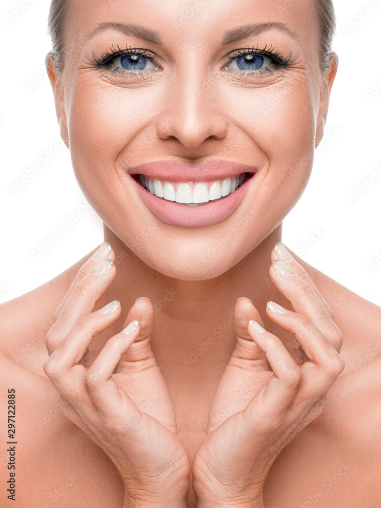 Happy smiling blue eyed woman touching her face. Happy smiling blue eyed woman touching her face.