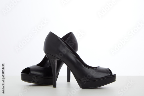 black high-heeled shoes on white