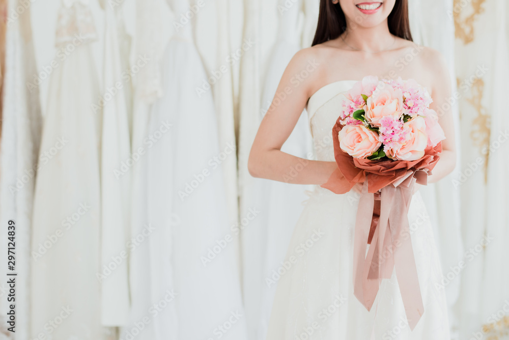 happy bride in wedding dress with bouquet of roses