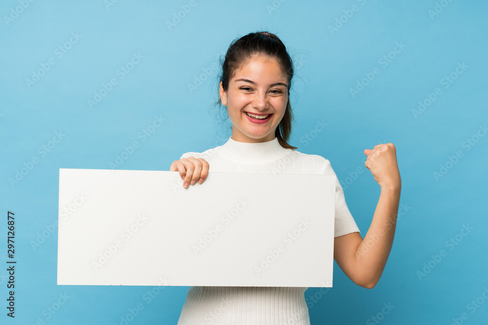 Young brunette girl over isolated blue background holding an empty white placard for insert a concept Young brunette girl over isolated blue background holding an empty white placard for insert a concept