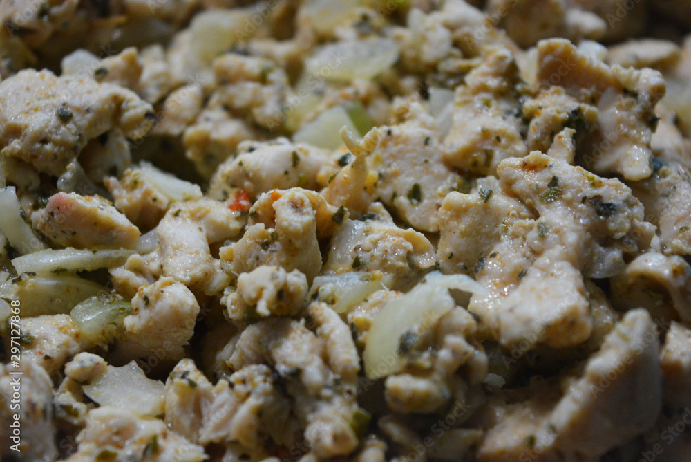 Finely chopped pieces of homemade chicken breast, fried and stewed with onions and sunflower oil. Slices of delicious, juicy chicken lying on a black skillet while frying. Finely chopped pieces of homemade chicken breast, fried and stewed with onions and sunflower oil. Slices of delicious, juicy chicken lying on a black skillet while frying.