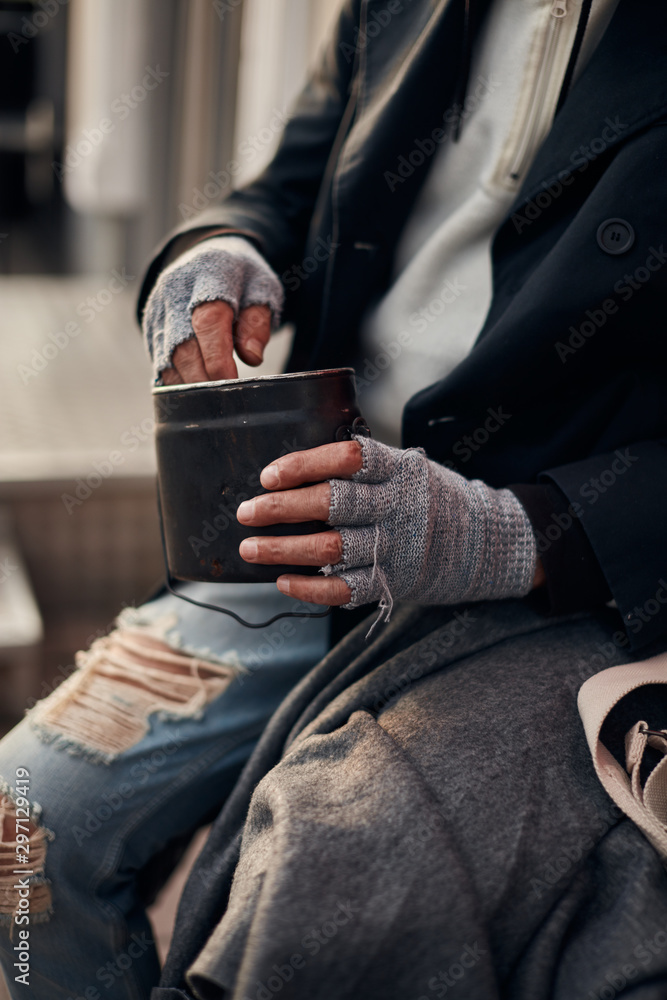 Homeless unrecognizable person holding money, dollar bill. Kind people help to poor. Beg for money concept Homeless unrecognizable person holding money, dollar bill. Kind people help to poor. Beg for money concept