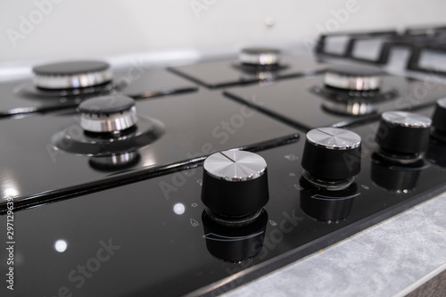 Fragment of a gas kitchen stove. Fragment of a gas kitchen stove. Clean gas stove closeup photo