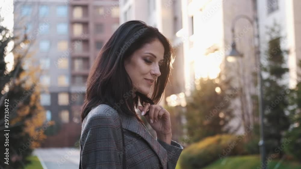 An attractive girl of European appearance looks at the camera on the street. An attractive girl of European appearance looks at the camera on the street.
