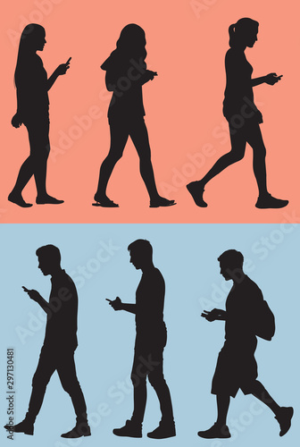 Silhouette of Teens Texting While They Walk