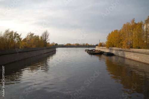 river in the city, in granite, on an autumn evening