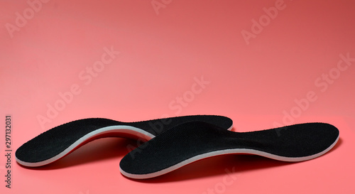 orthopedics on a pink background. Paste in shoes to support the foot. Flatfoot Correction