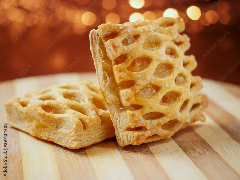 One apple lattice on a wooden board, warm tones, blurred background. Close up, Selective focus. Pastry product. One apple lattice on a wooden board, warm tones, blurred background. Close up, Selective focus. Pastry product.