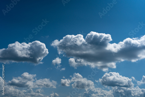 Glowing clouds on a background of blue sky. White fluffy luminous cloud