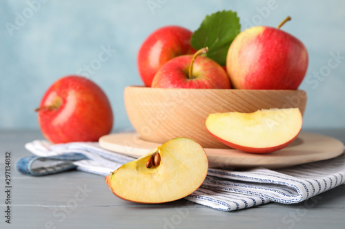 Apples in bowl on wooden background, close up 