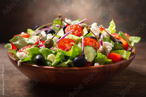 Fotografia bowl of fresh salad with vegetables, feta cheese and capers