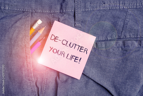 Conceptual hand writing showing De Clutter Your Life. Concept meaning remove unnecessary items from untidy or overcrowded places Writing equipment and pink note paper inside pocket of trousers