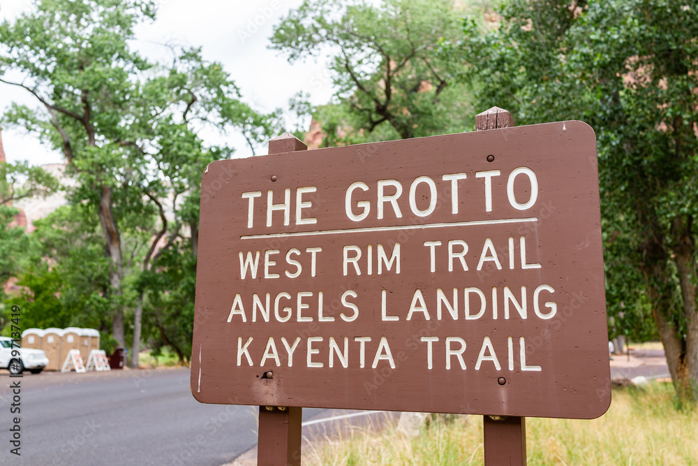 Zion National Park parking lot stop on road in Utah with sign for the grotto west rim, kayenta and Angel's Landing trails