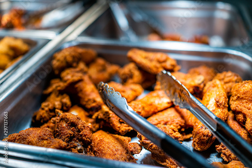 Obraz na plátně Fried chicken buffet bar self serve with tongs in grocery store, restaurant or c
