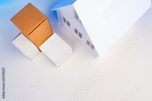 Boxes near the house. Concept - delivery of goods from online stores. Parcels at the door. Delivery to the door. Moving to a new home. Concept - transport company. Logical business. Multi-colored box