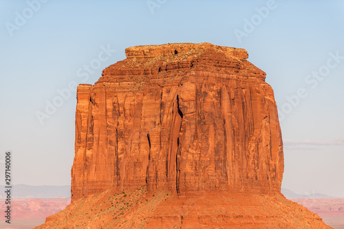 View of famous Merrick butte mesa formations closeup with red orange rock color on horizon in Monument Valley canyons during sunset in Arizona photo