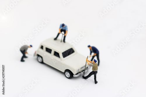 Miniature people: Workers fixing car. car service, repair, maintenance concept.