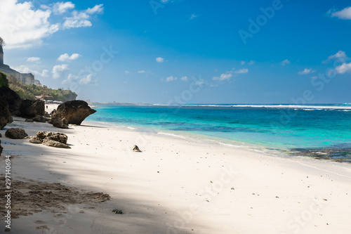 Tropical beach with white sand, blue ocean and clear sky
