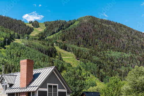 Canvas Print Ski resort town house with modern roof architecture typical building exterior in
