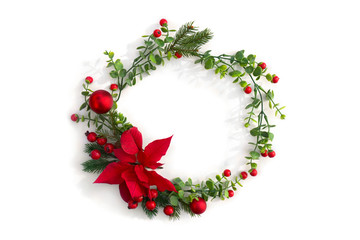 Christmas decoration. Frame of flower of red poinsettia, branch christmas tree, christmas ball, red berry on a white background with space for text. Top view, flat lay