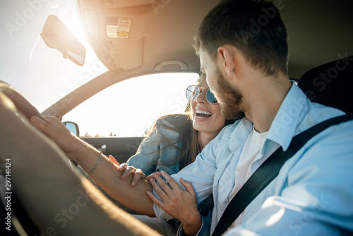 Pretty girl is extremely contented with the car trip arranged by her boyfriend