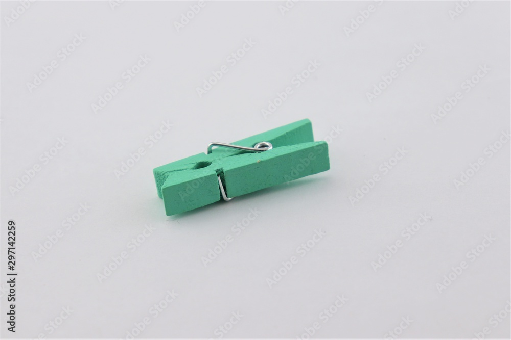 Little green clothespin on a gray background. Little green clothespin on a gray background.