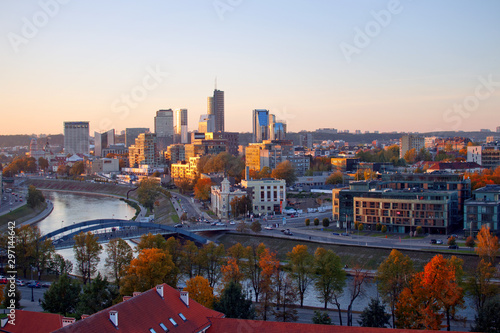 Cityscape view to new town ("Naujamiestis") with modern buildings at another side of Neris river during the sunset at autumn evening.