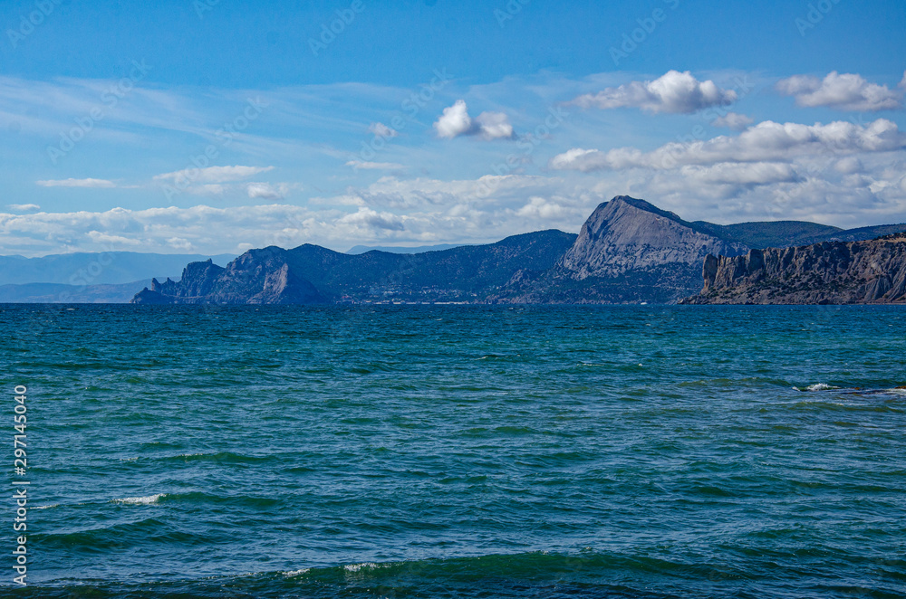 Seascape, sea and mountains, sunny summer day.