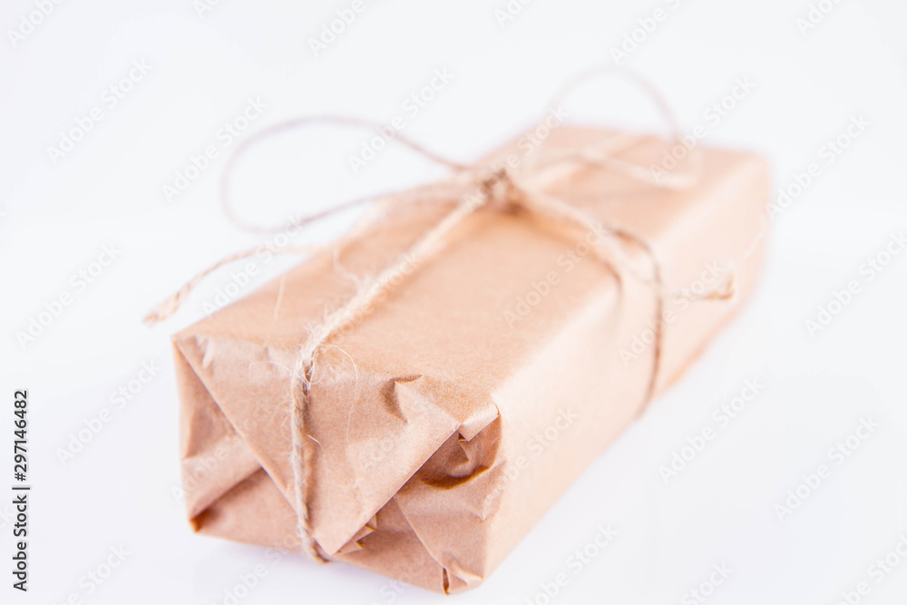Gift decorated with a gunny string bow on a white background Gift decorated with a gunny string bow on a white background
