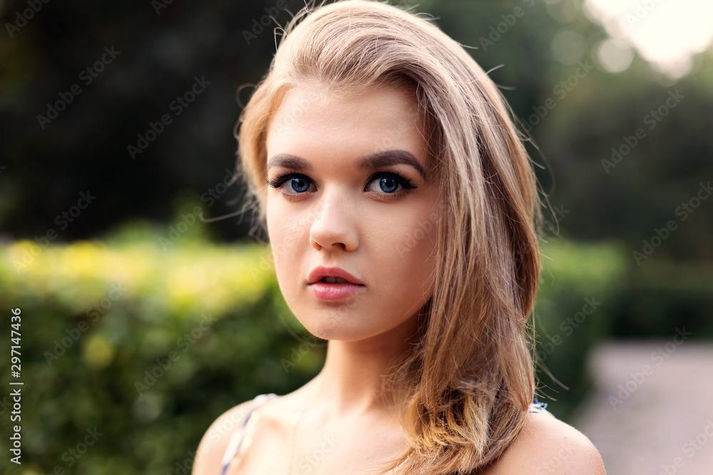 Closeup portrait of a young attractive girl against blurred background. Shallow focus. Closeup portrait of a young attractive girl against blurred background. Shallow focus.