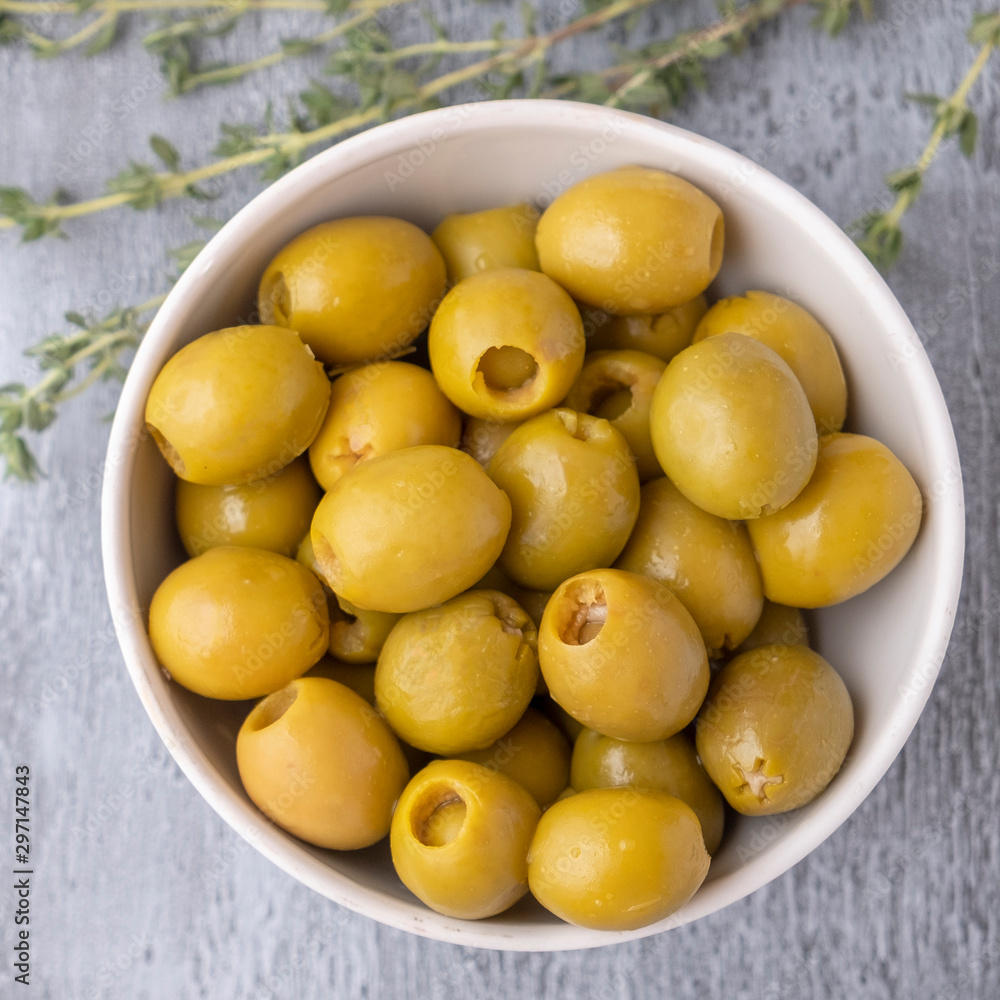 Green olives on grey background. Top view Green olives on grey background. Top view