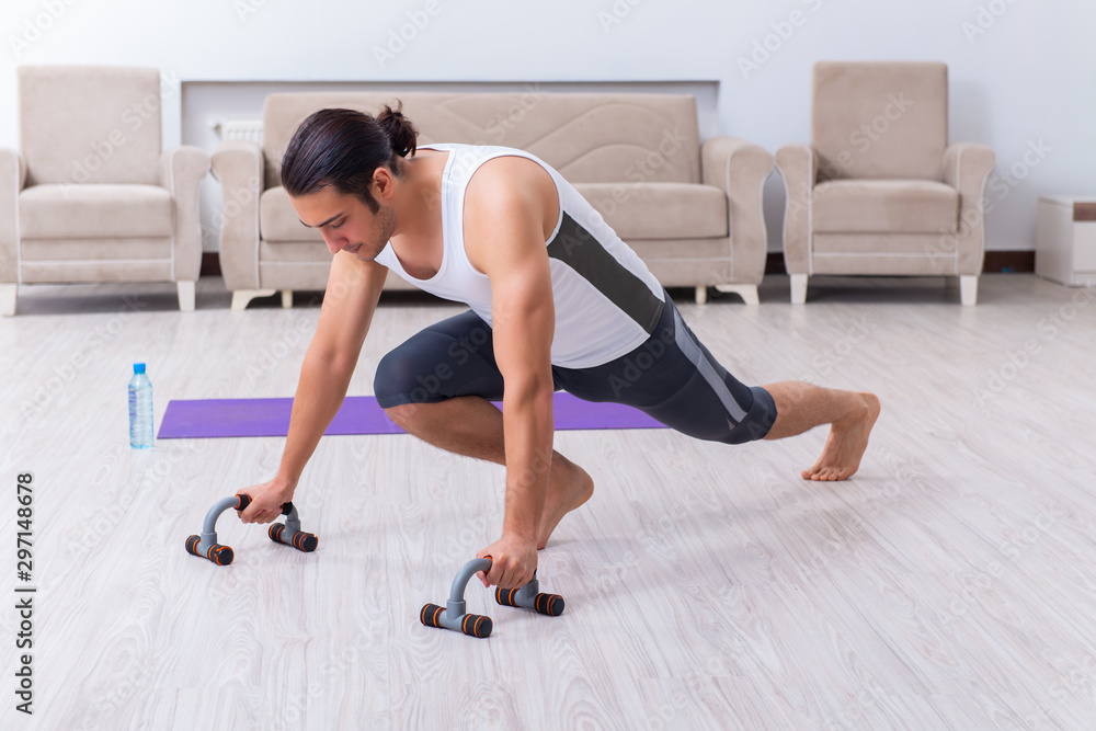 Young man training and exercising at home Young man training and exercising at home