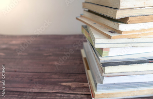 close up Many books are stacked on a wooden table. Educational concepts and reading Learning to enhance knowledge in schools and universities.