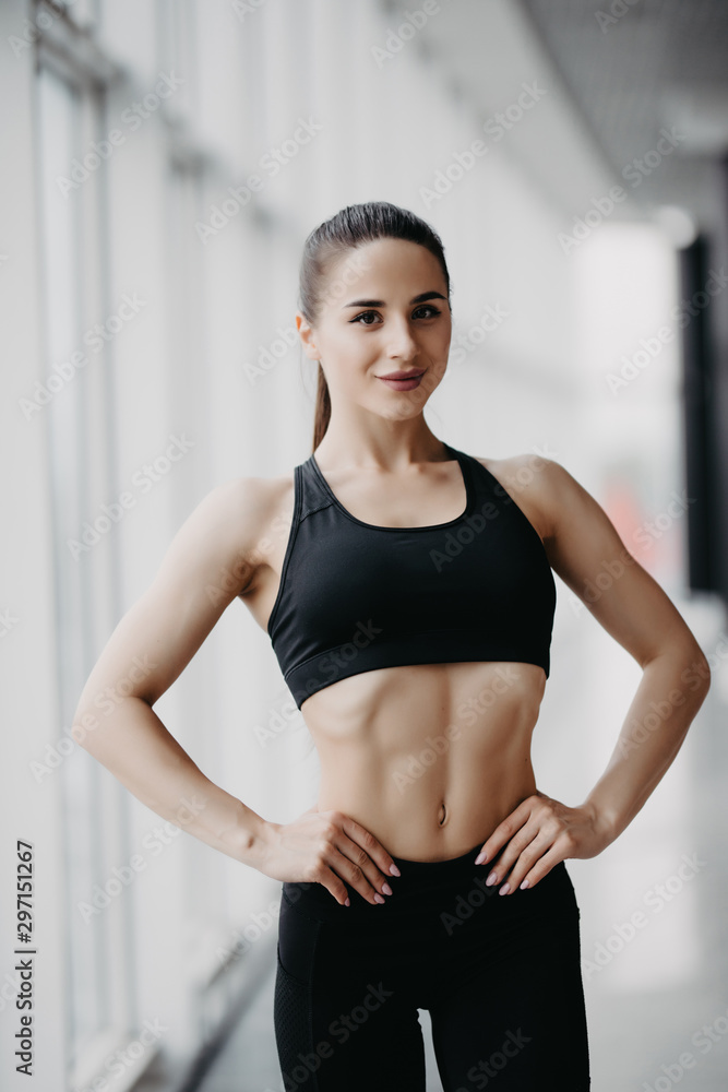 Attractive fitness woman trained female body at gym
