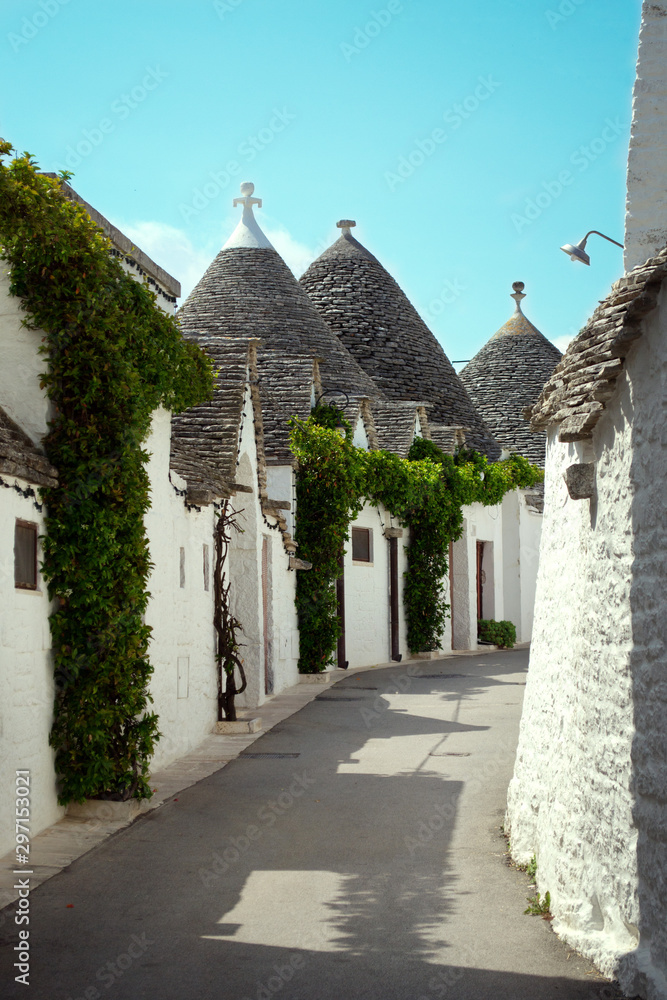 Street with unique white buildings with conical roof called 
