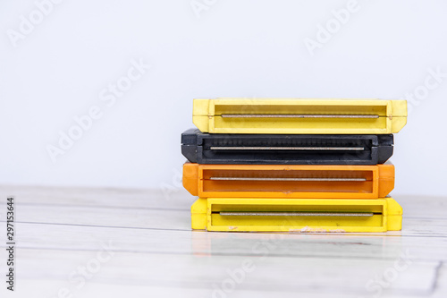 Old gaming cassettes on a wooden white table. Text space.