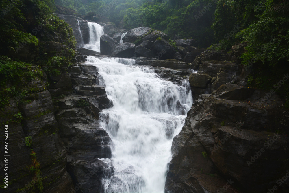 Close up of waterfall in Shillong in motion blurr and rocks, selective focusing Close up of waterfall in Shillong in motion blurr and rocks, selective focusing