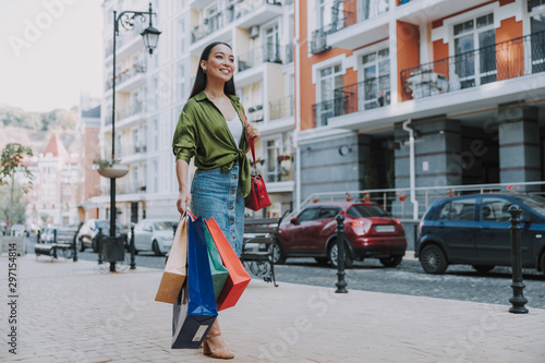 Happy Asian woman is walking after shopping