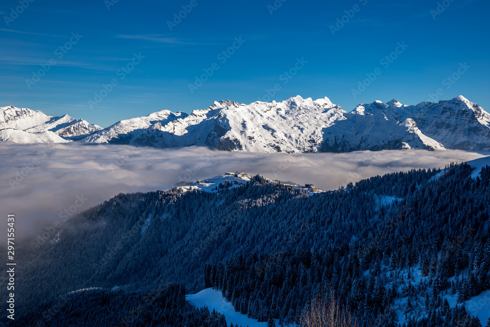 Inversion in valley and illuminated mountain peaks Inversion in valley and illuminated mountain peaks