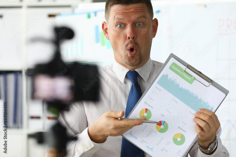 Astonished businessman hold in hand business