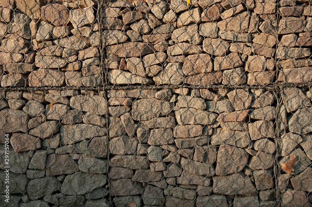 Stone wall. Stones behind the wire Stone wall. Stones behind the wire