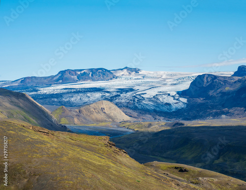 Icelandic landscape with eyjafjallajokull glacier tongue  Markarfljot river and green hills. Fjallabak Nature Reserve  Iceland. Summer blue sky
