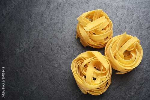Fettuccine pasta on black background