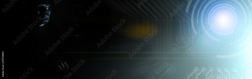 A man in a mask prints on the keyboard in the dark A man in a mask prints on the keyboard in the dark