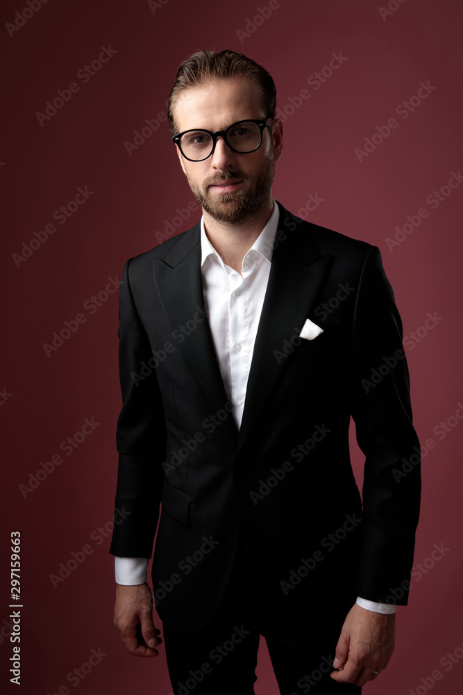 Dramatic elegant man looking forward while wearing glasses Dramatic elegant man looking forward while wearing glasses