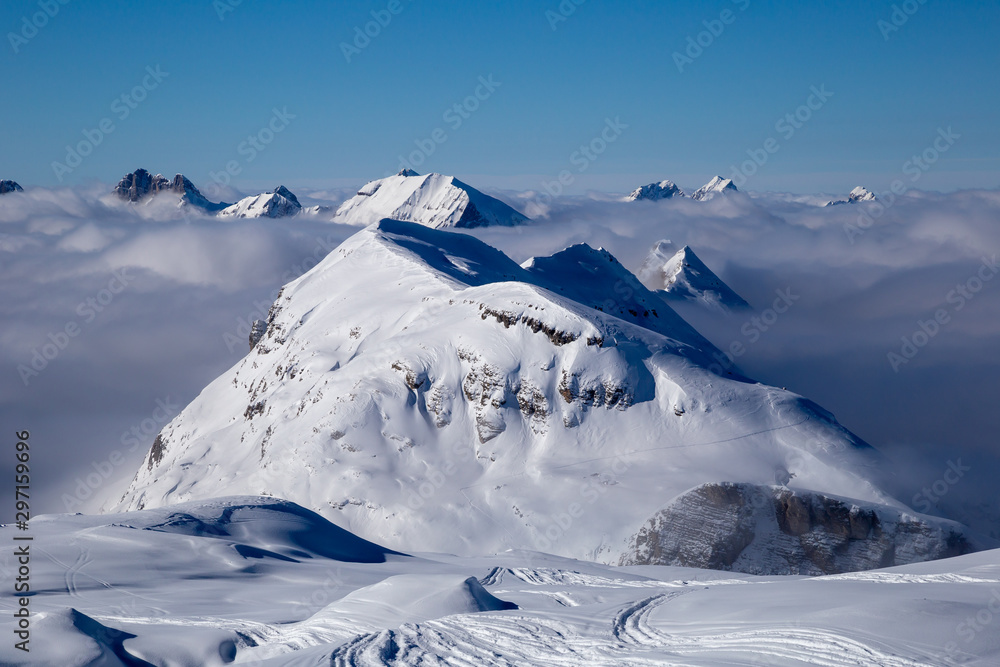 Panorama of mountains rising from the clouds