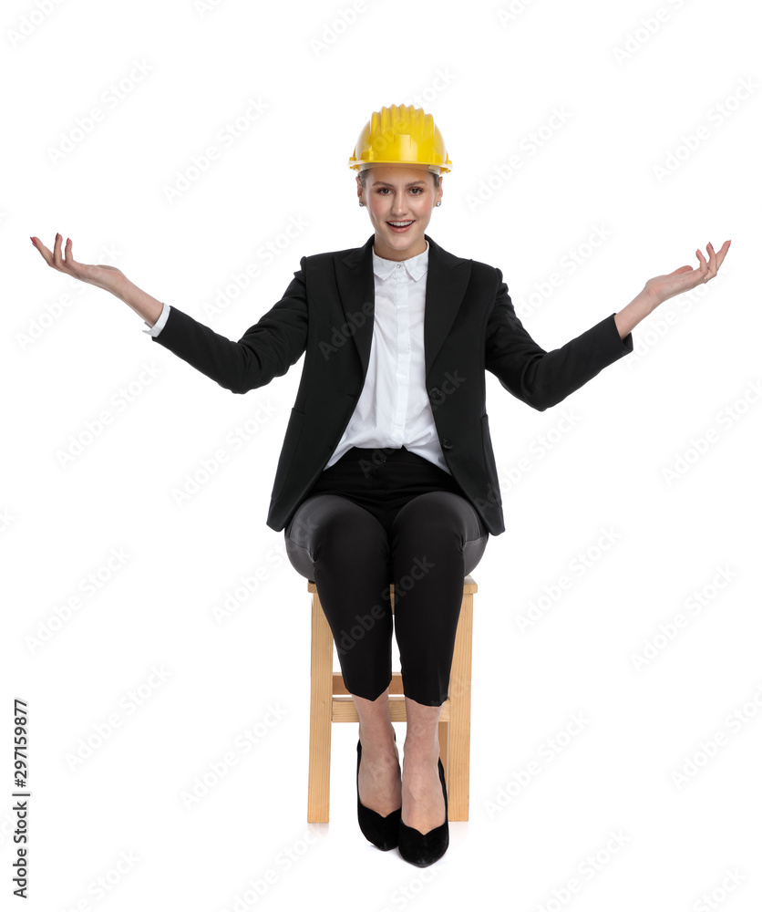 businesswoman wearing yellow helmet and greeting businesswoman wearing yellow helmet and greeting