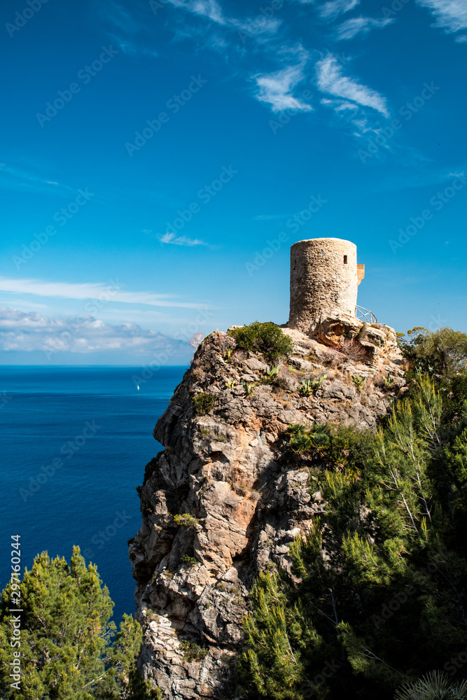 Ancient old historic tower at the wild mountain coastline with ocean view. Torre des Verger, Serra de Tramuntana, Mallorca, Spain