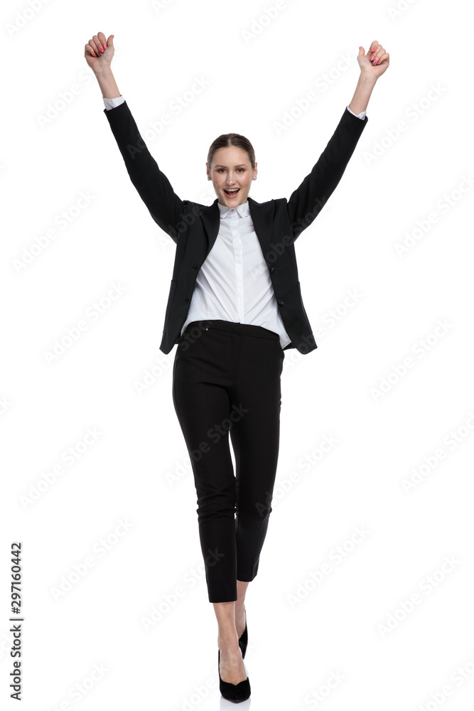 businesswoman walking with hands up in the air businesswoman walking with hands up in the air